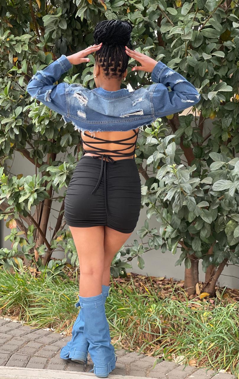 Fashion-forward ripped short denim jacket, ideal for layering and adding edge to your look