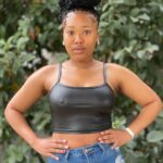 Black faux leather crop top for women with spaghetti straps, styled for a bold and modern johannesburg look