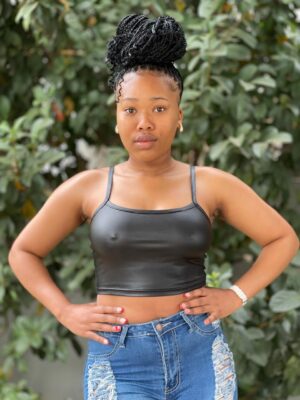 Black faux leather crop top for women with spaghetti straps, styled for a bold and modern johannesburg look