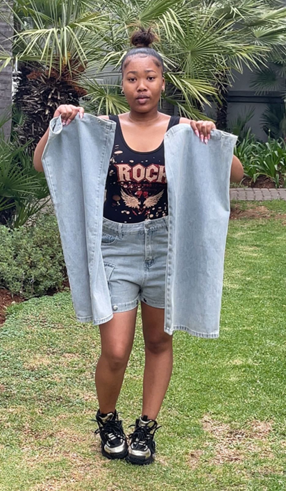 A lady showcasing the different jean materials that we use to create jean clothing in johannesburg